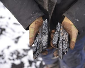 miner holding coal