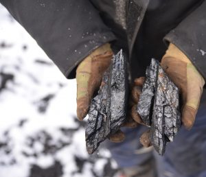miner holding coal